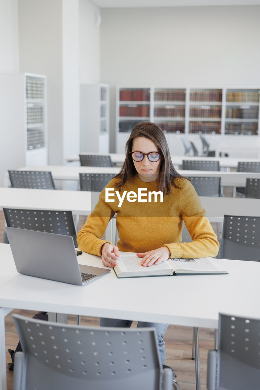 portrait of businesswoman using laptop at office