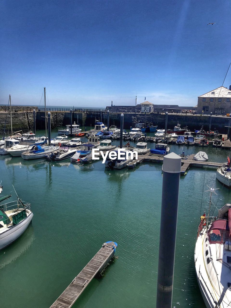 BOATS MOORED AT HARBOR