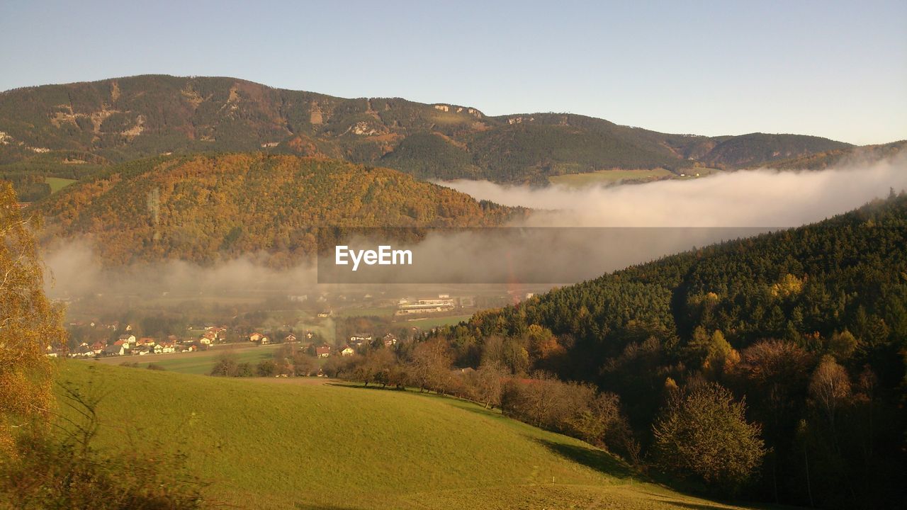 Scenic view of fog covering mountains