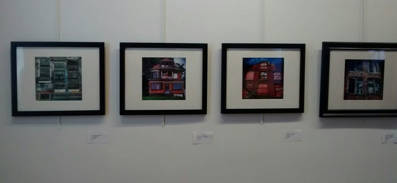 Photographs on wall displayed in exhibition