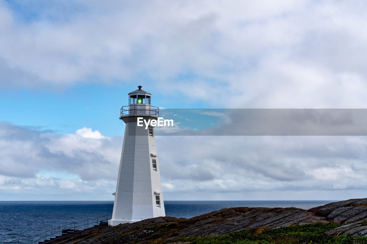 LIGHTHOUSE BY SEA AGAINST SKY AND BUILDING