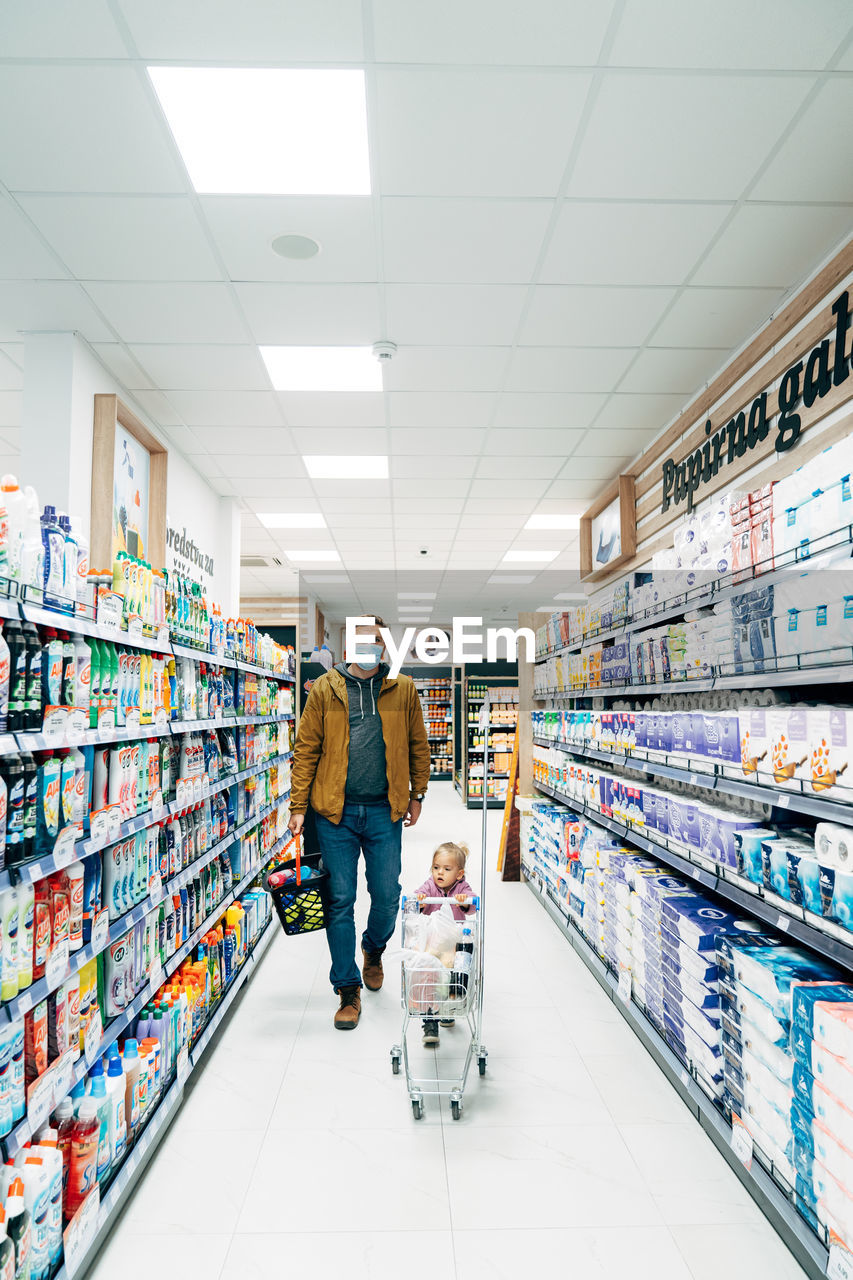 FULL LENGTH OF FRIENDS STANDING ON STORE