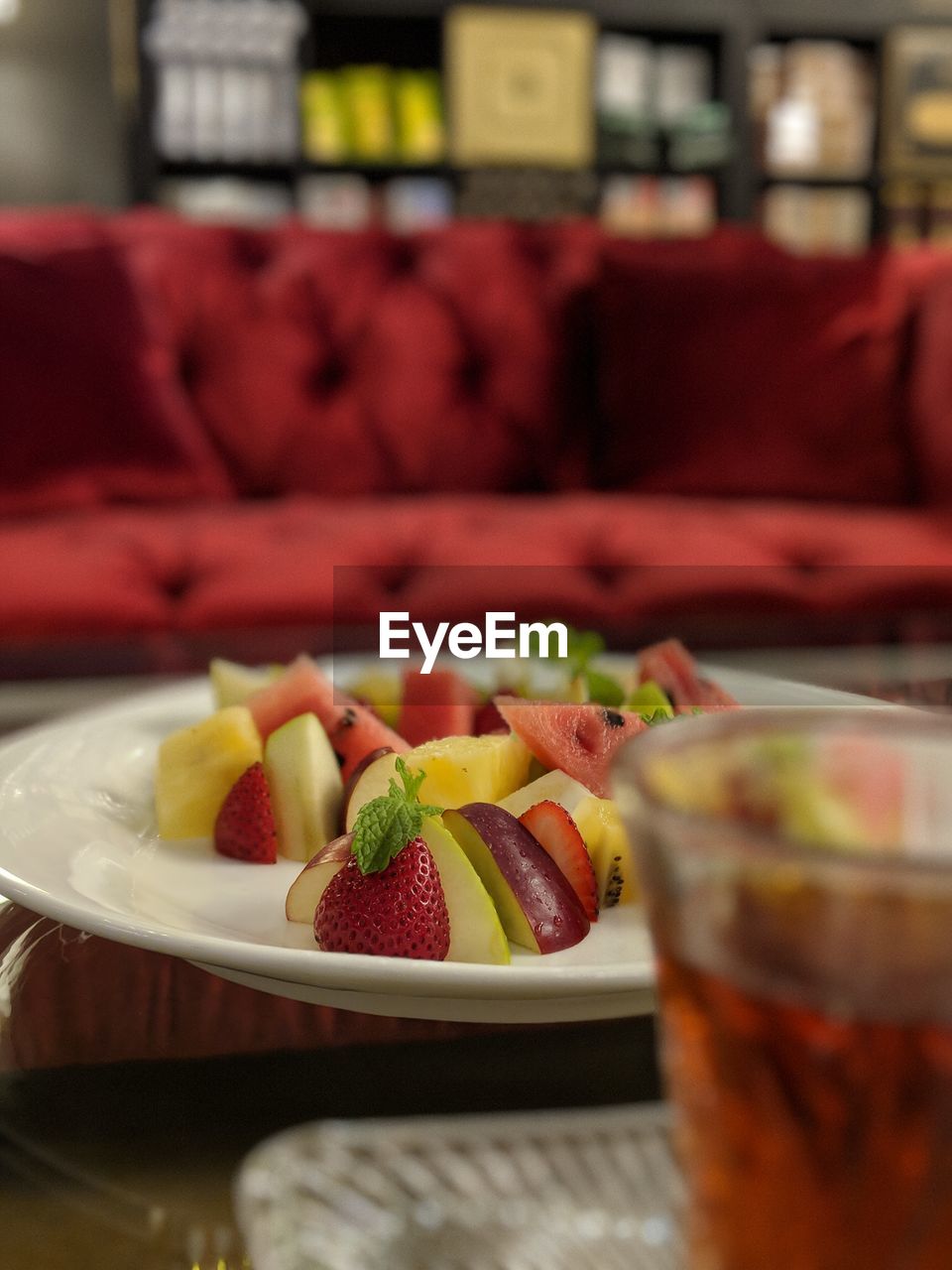 High angle view of fruits by drink on table