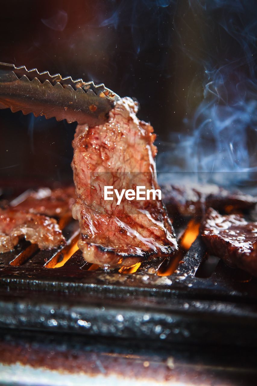 CLOSE-UP OF MEAT IN BARBECUE