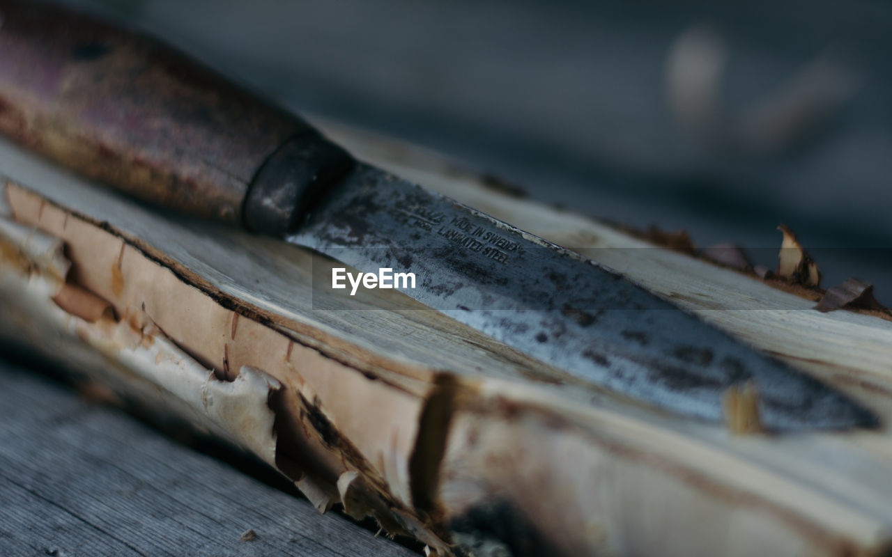 Close-up of knife on wood