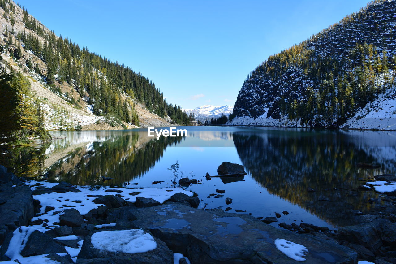 Scenic view of lake against sky during winter