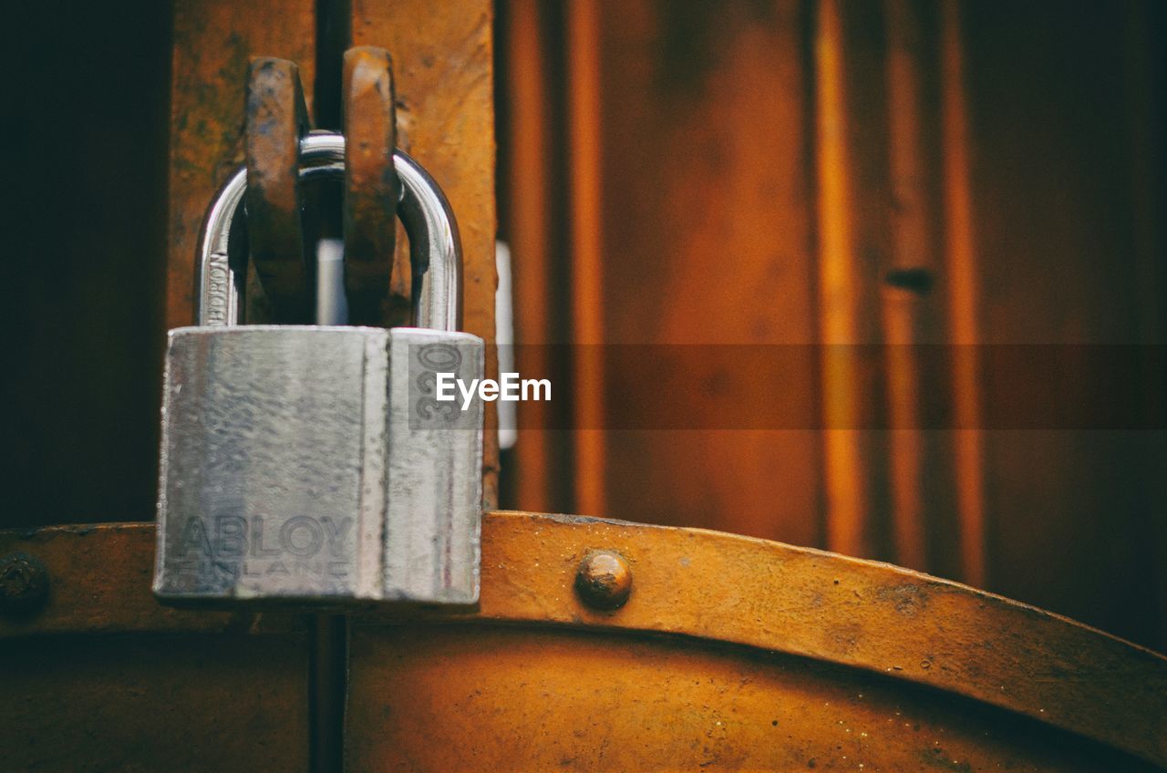 Cropped image of silver padlock on metal gate