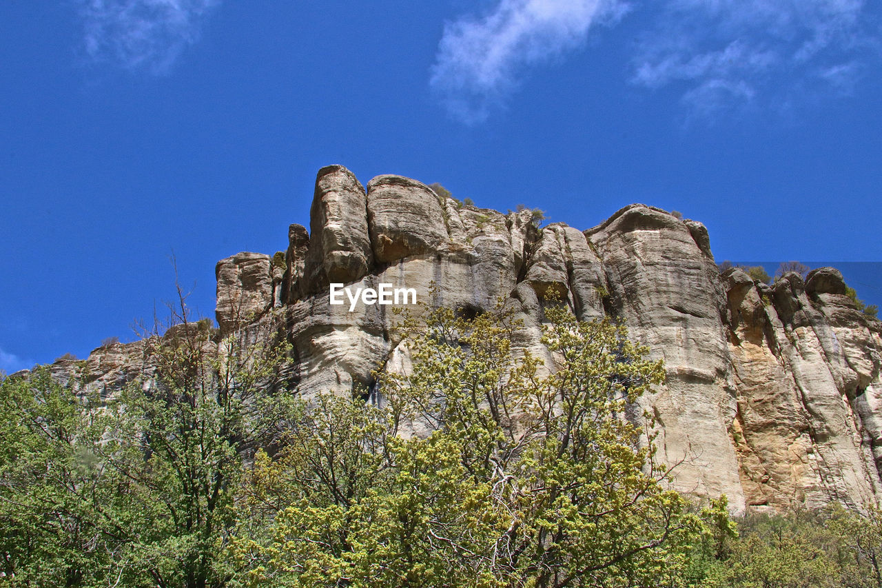 Low angle view of rock formations against sky