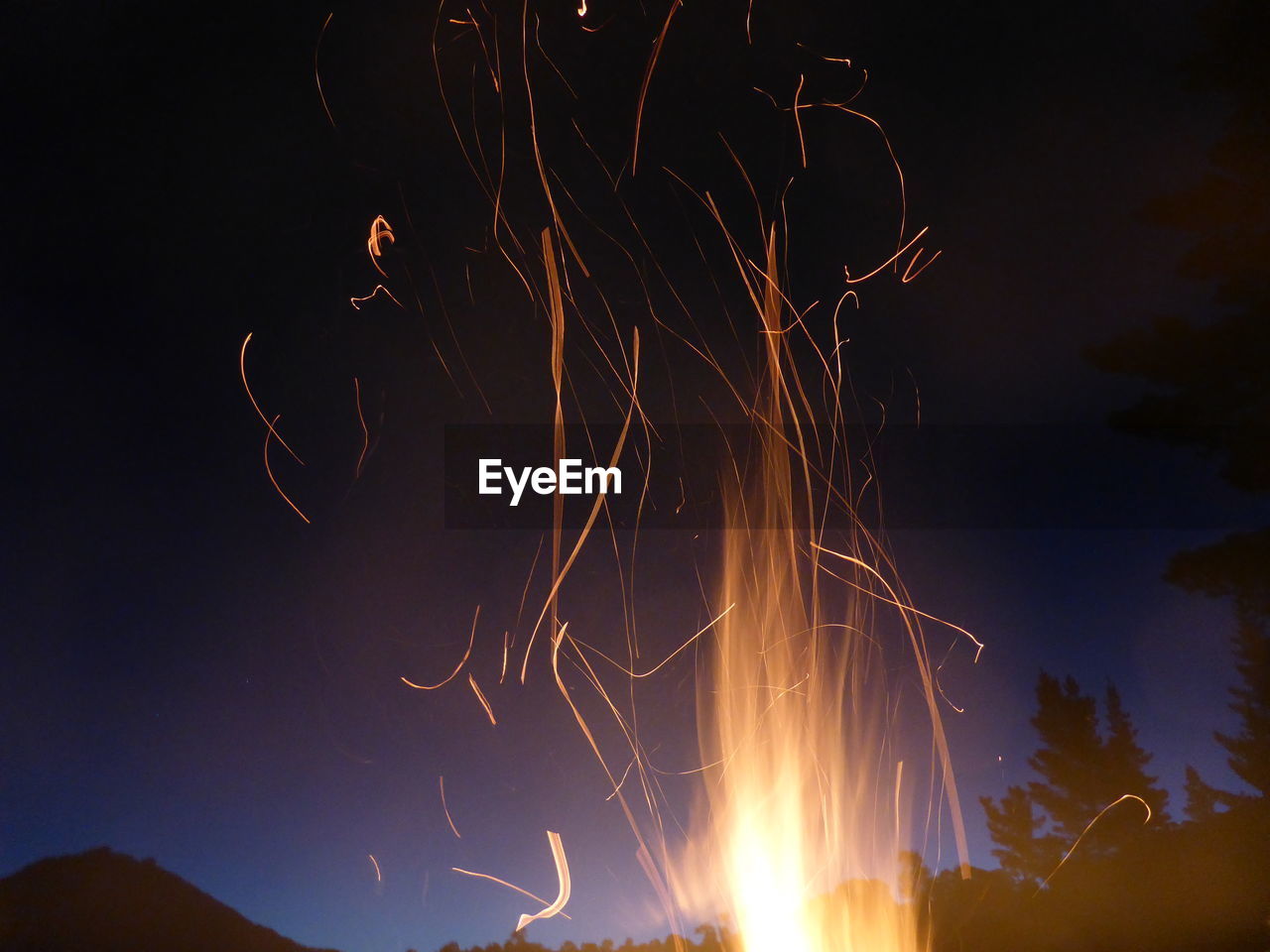 LOW ANGLE VIEW OF FIREWORK DISPLAY IN SKY