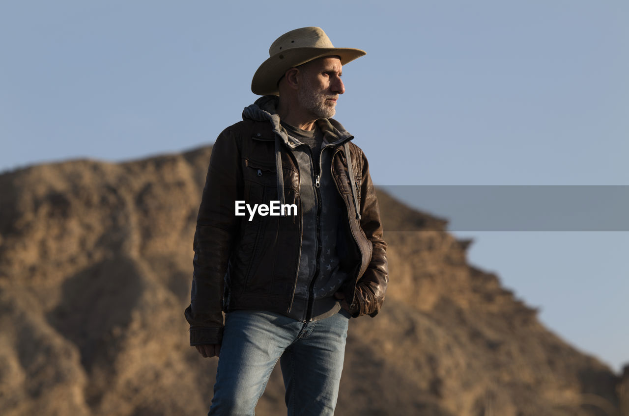 Adult man in cowboy hat in tabernas desert, almeria, spain