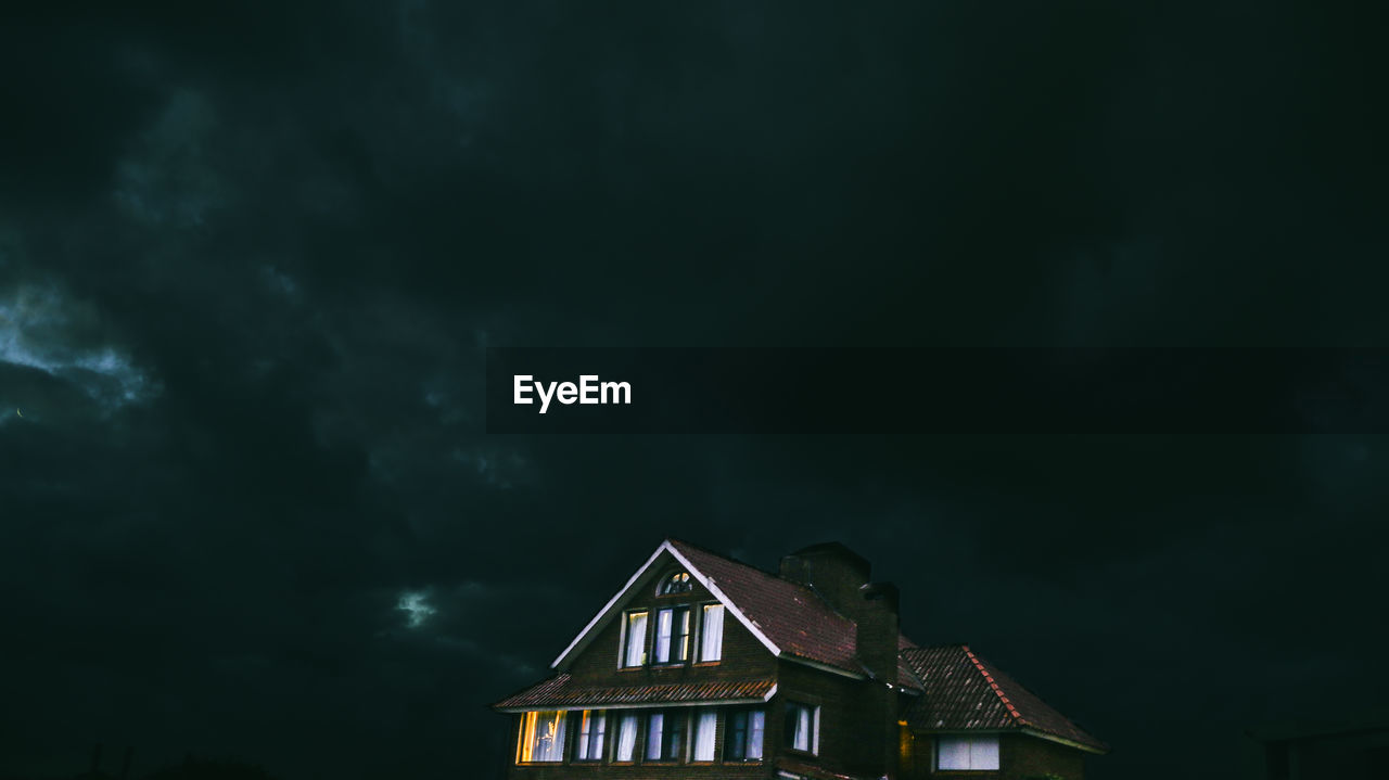 Low angle view of house against sky at night