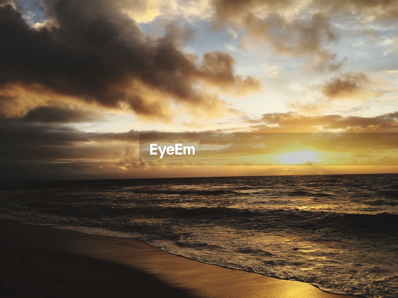 Scenic view of beach against sky during sunset