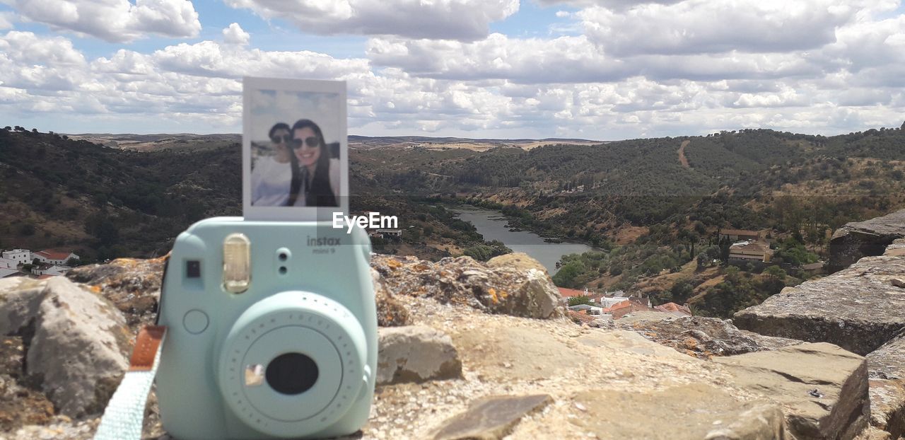 HIGH ANGLE VIEW OF CAMERA PHOTOGRAPHING ON MOUNTAIN