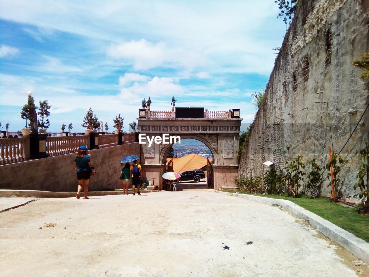 People at historical building against sky