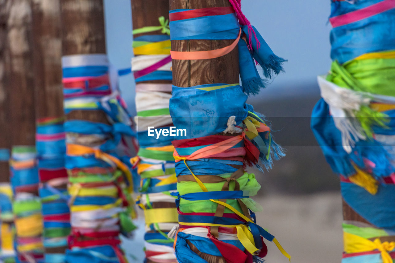 CLOSE-UP OF MULTI COLORED UMBRELLAS HANGING ON DISPLAY