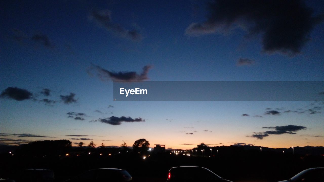 SCENIC VIEW OF SUNSET SKY OVER SILHOUETTE LANDSCAPE