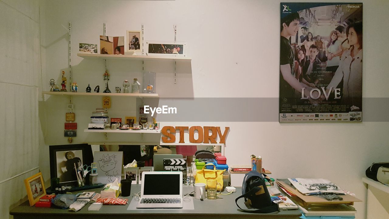 STACK OF OBJECTS ON SHELF