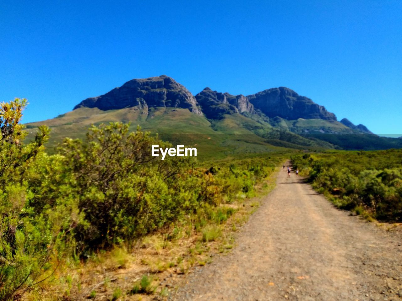 Scenic view of mountains against clear blue sky