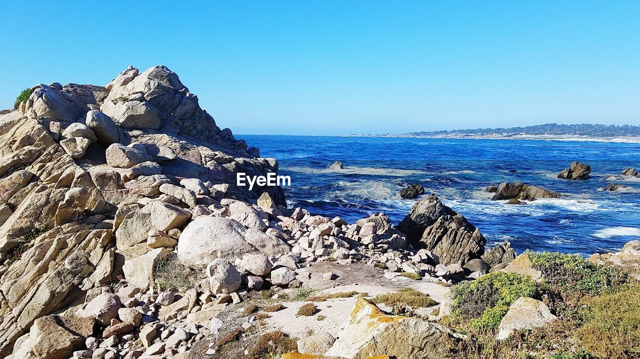 Scenic view of sea against clear blue sky