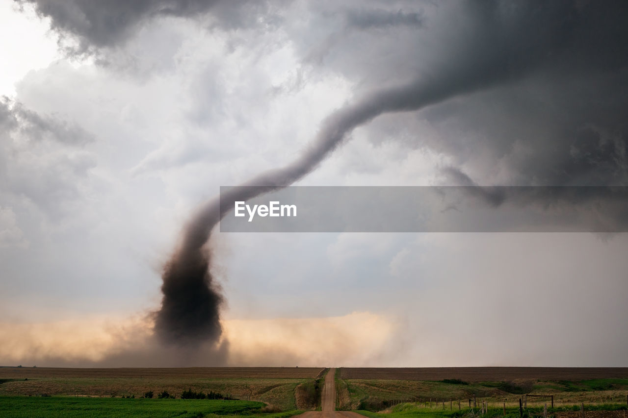 A tornado spins beneath a supercell thunderstorm during a severe weather outbreak in nebraska.