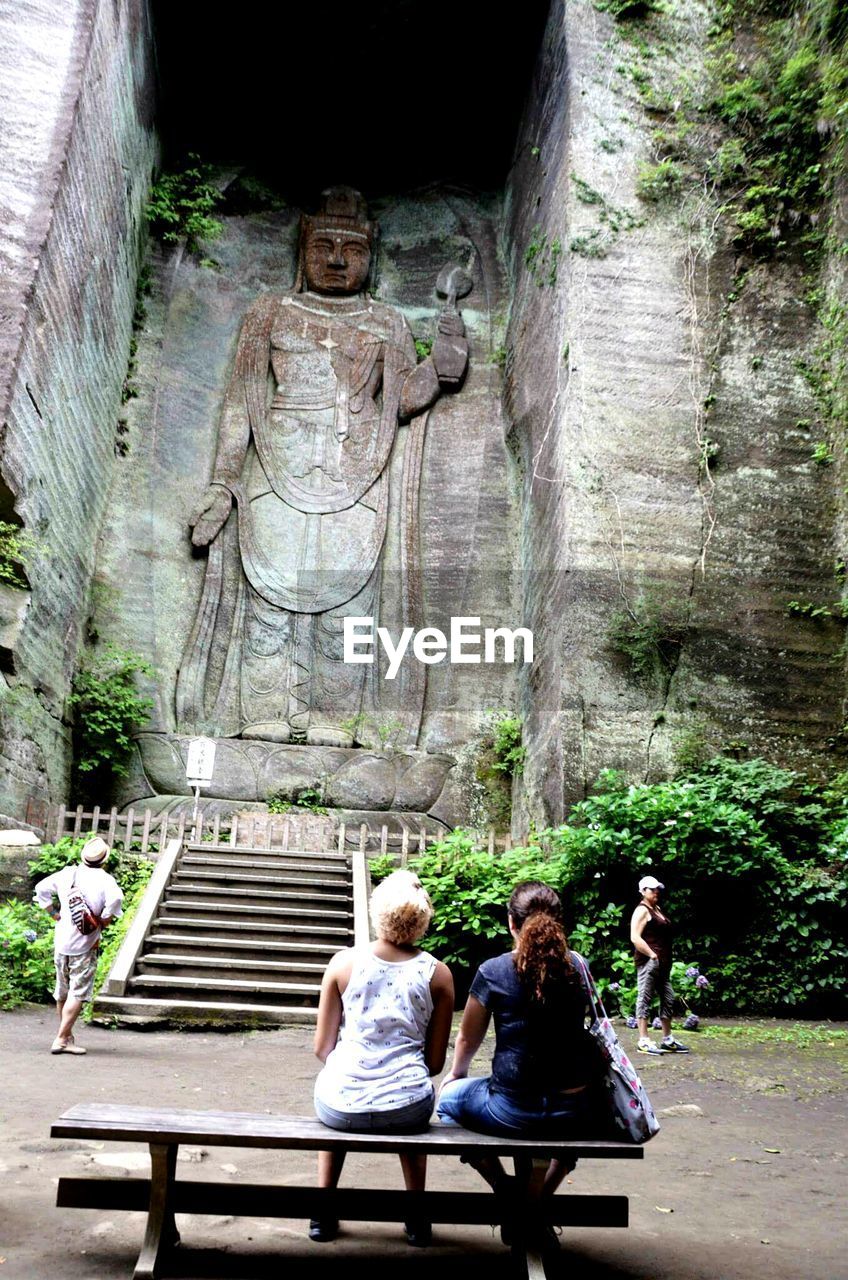 Rear view of people in front of japanese temple