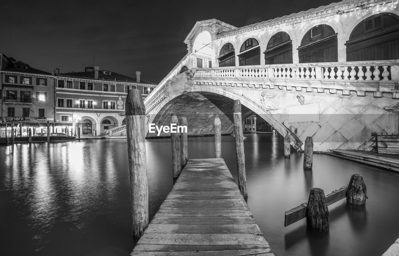 Jetty against rialto bridge over grand canal in city