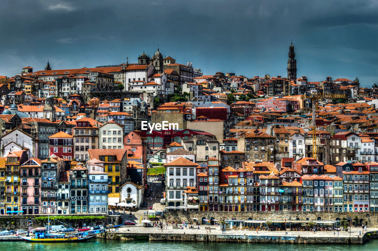 View of cityscape against cloudy sky