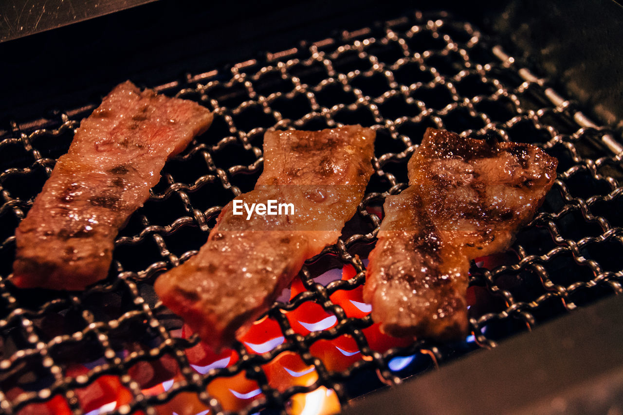 Close-up of meat cooking in barbecue grill