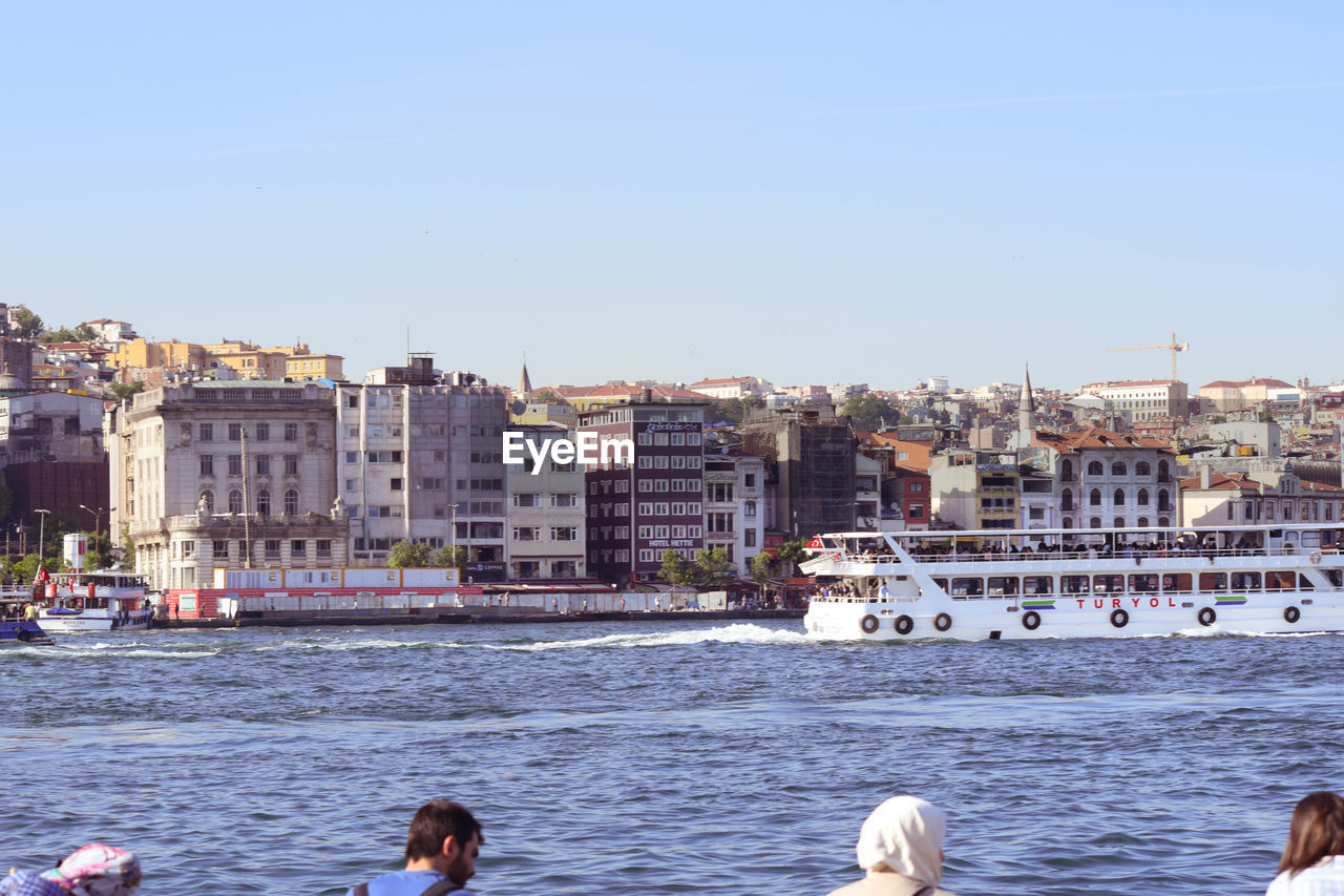 VIEW OF SEA AGAINST BUILDINGS IN CITY