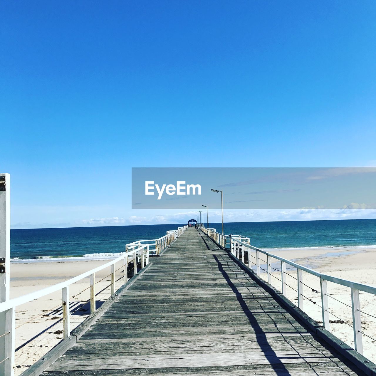 PIER OVER SEA AGAINST CLEAR SKY