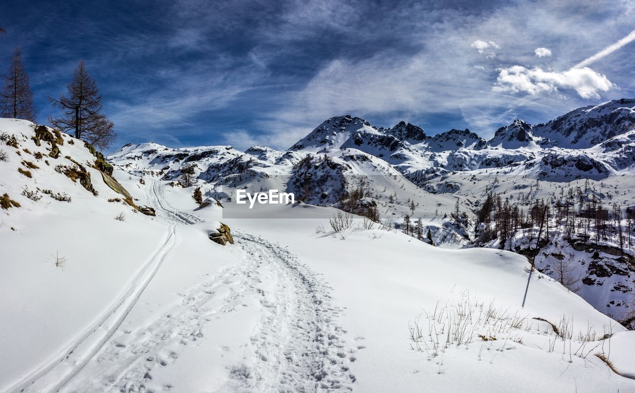 Scenic view of snow covered mountains against sky