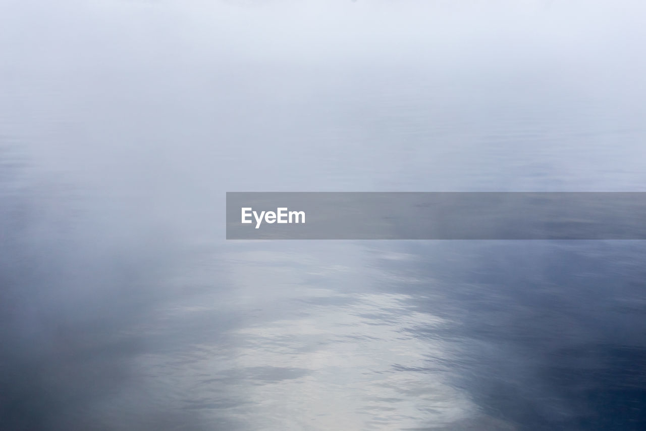 Full frame shot of foggy water surface on lake at morning
