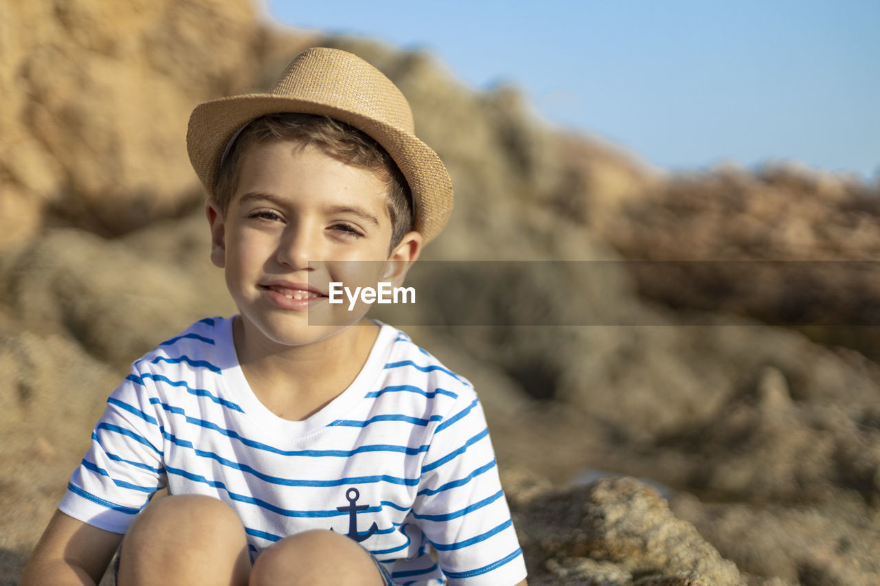 Portrait of smiling boy in rock