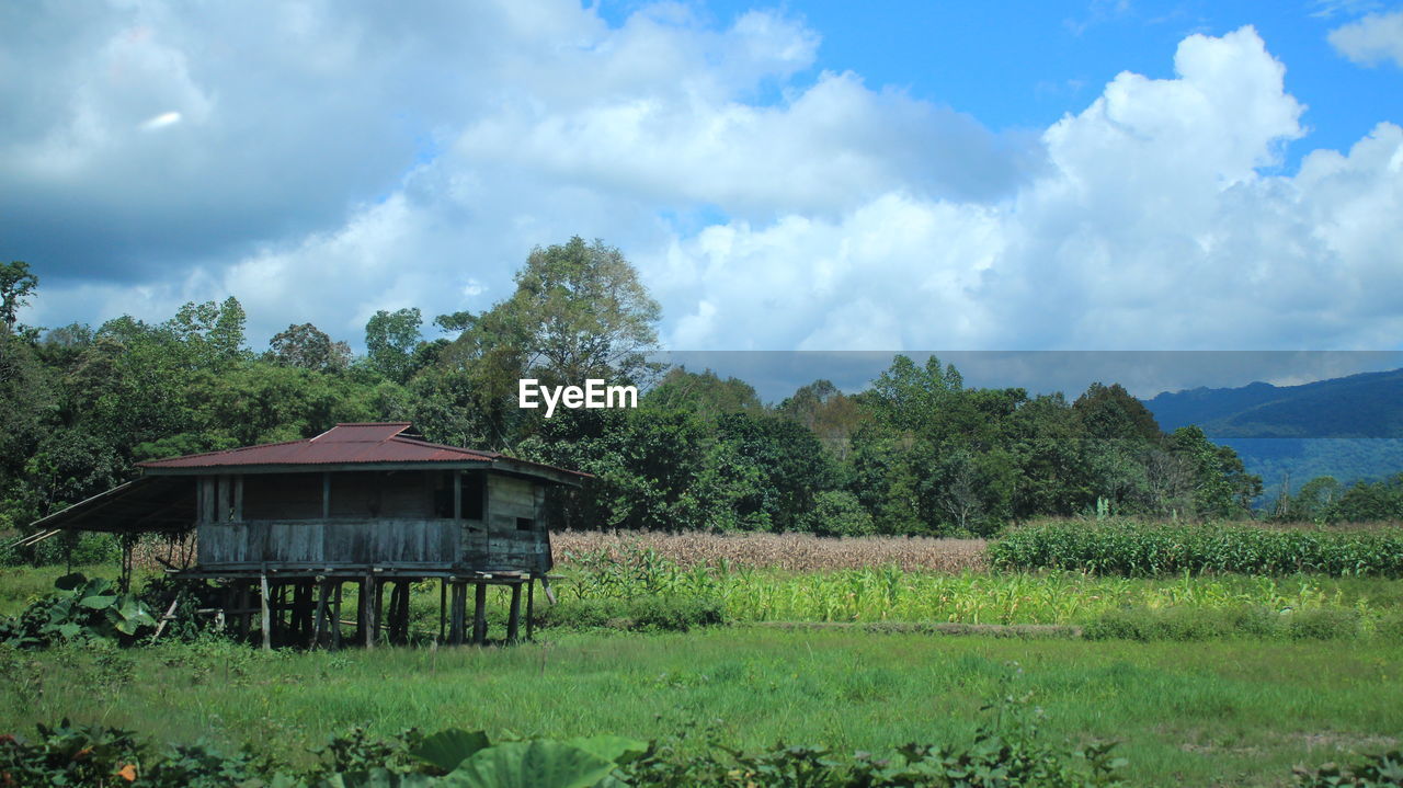 Built structure on field against sky