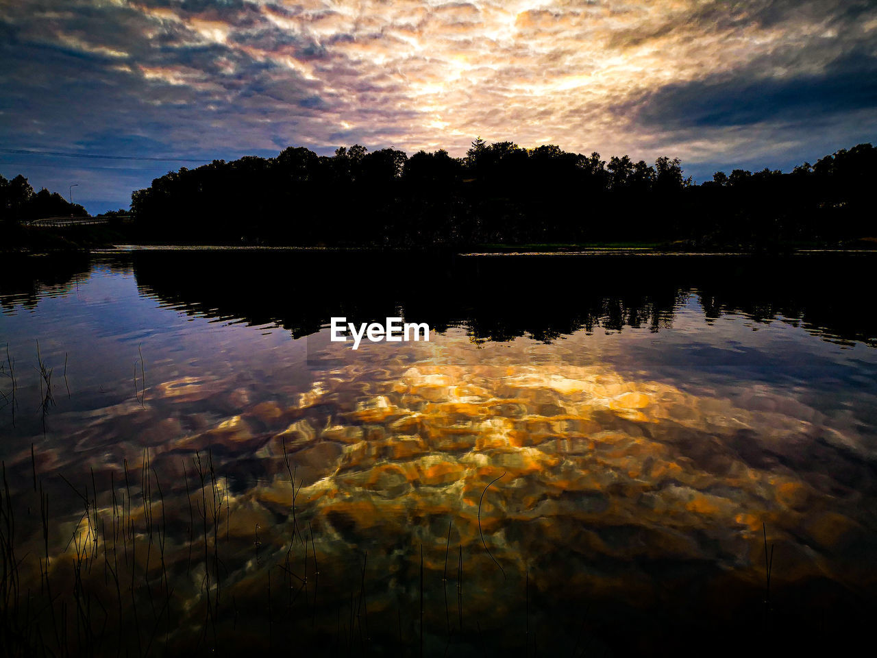 SCENIC VIEW OF LAKE BY SILHOUETTE TREES AGAINST SKY