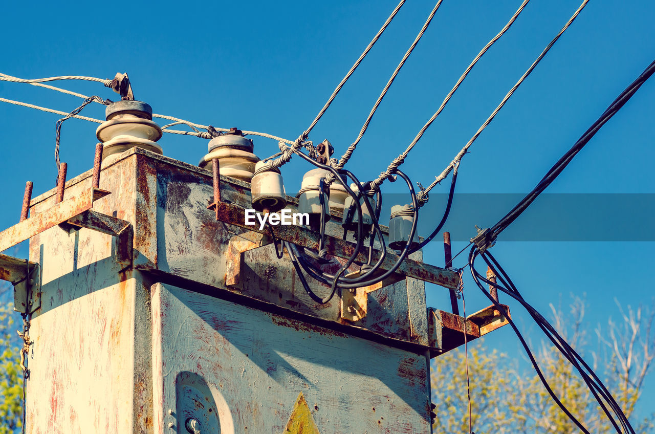 Transformer booth with high voltage power lines. blue sky background