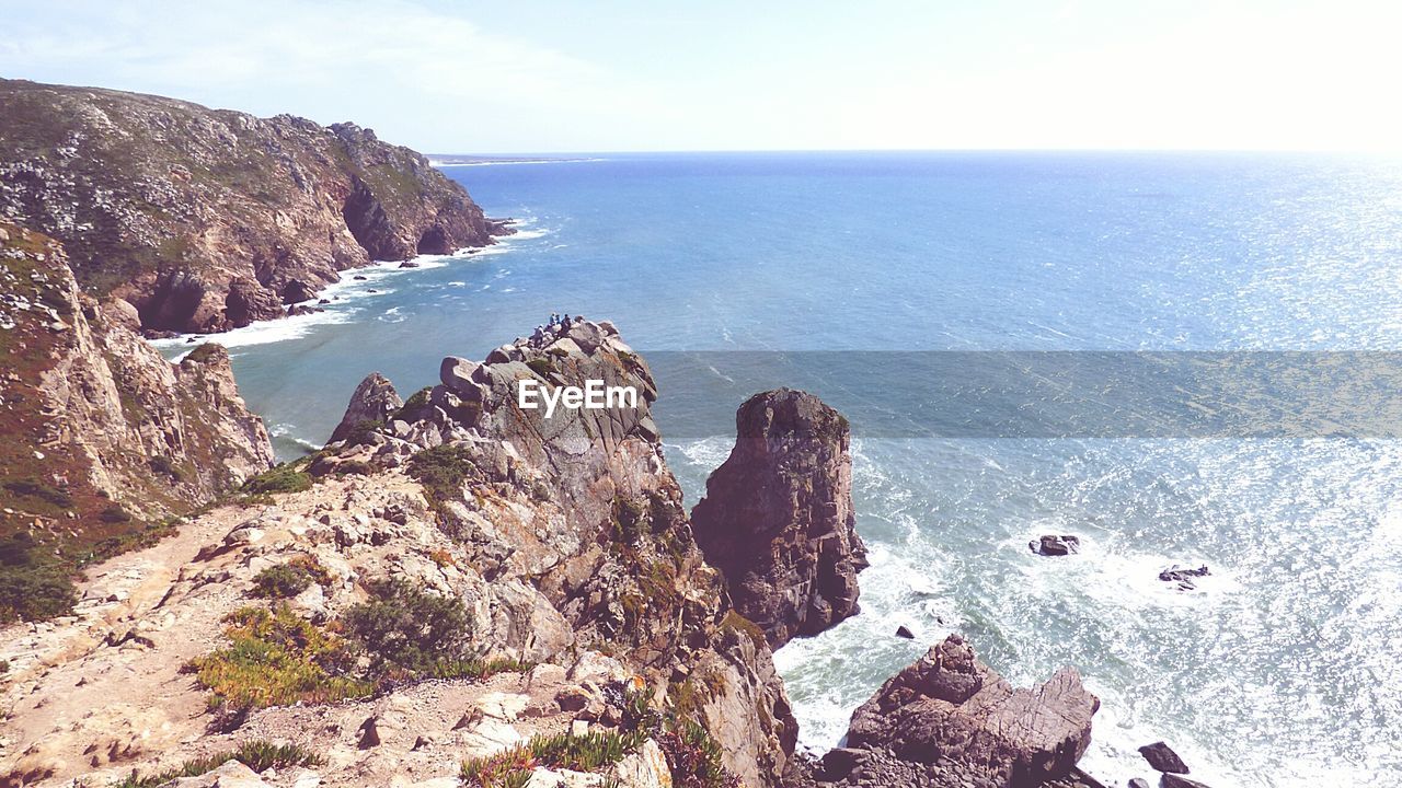 SCENIC VIEW OF SEA WITH ROCKS IN BACKGROUND