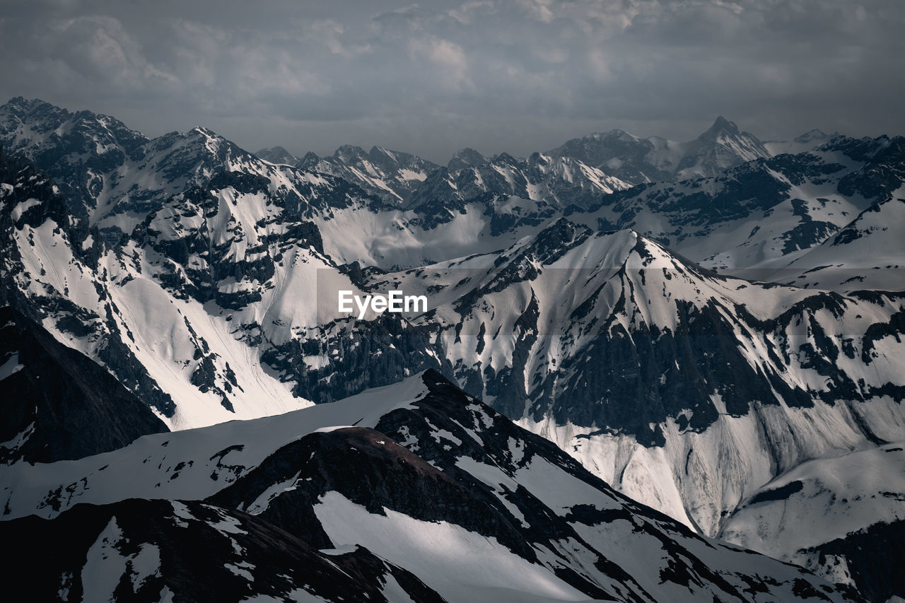 Scenic view of snow covered mountains against sky