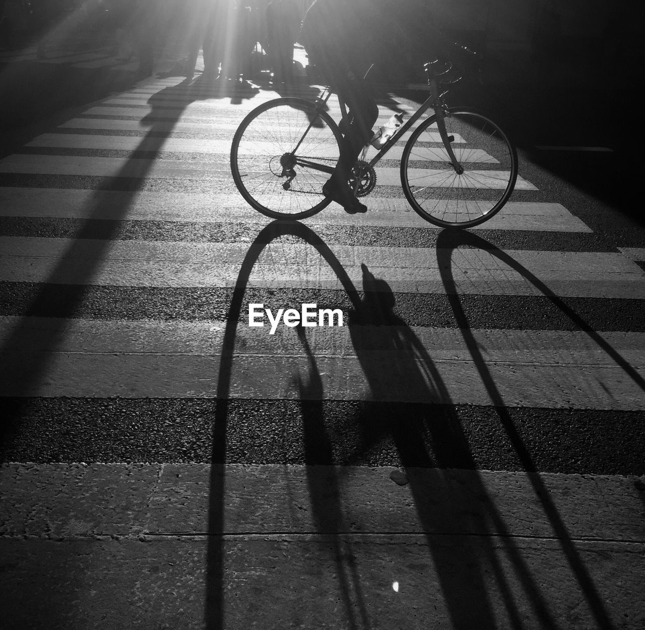 LOW SECTION OF SILHOUETTE MAN CYCLING ON BICYCLE