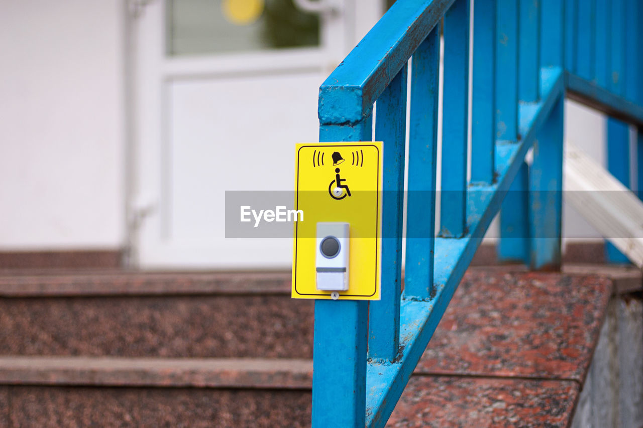 CLOSE-UP OF YELLOW SIGN ON DOOR