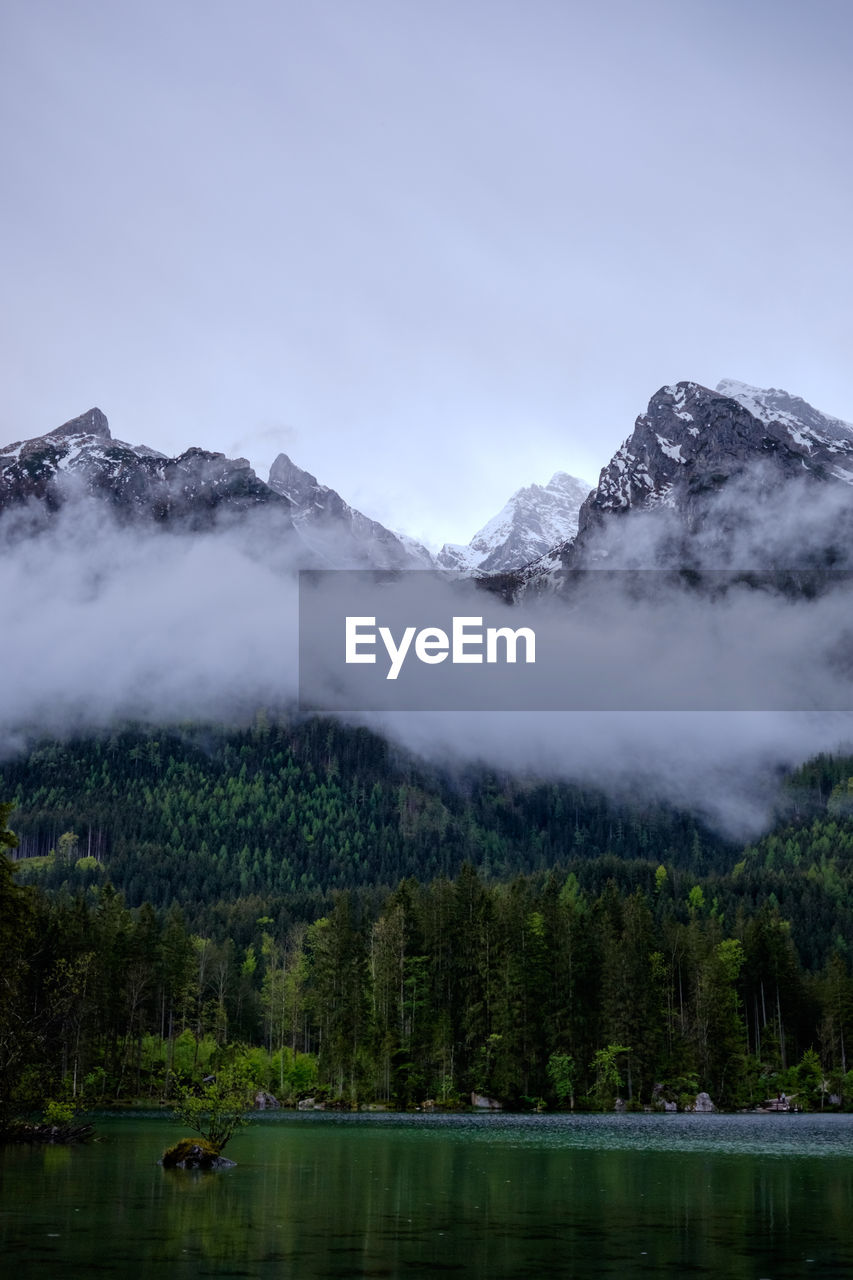 SCENIC VIEW OF LAKE AGAINST MOUNTAINS DURING WINTER