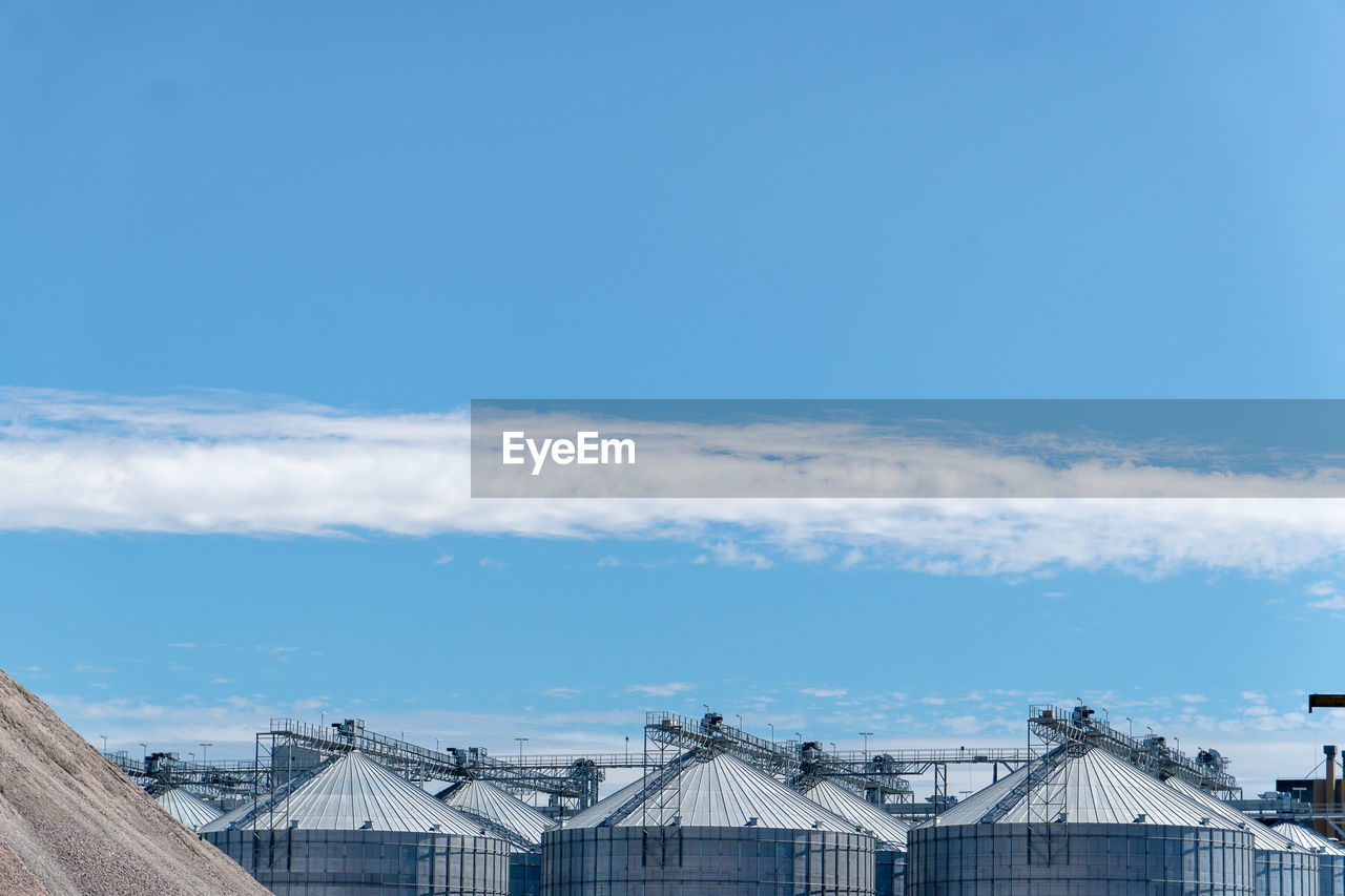 Section of silos against blue sky