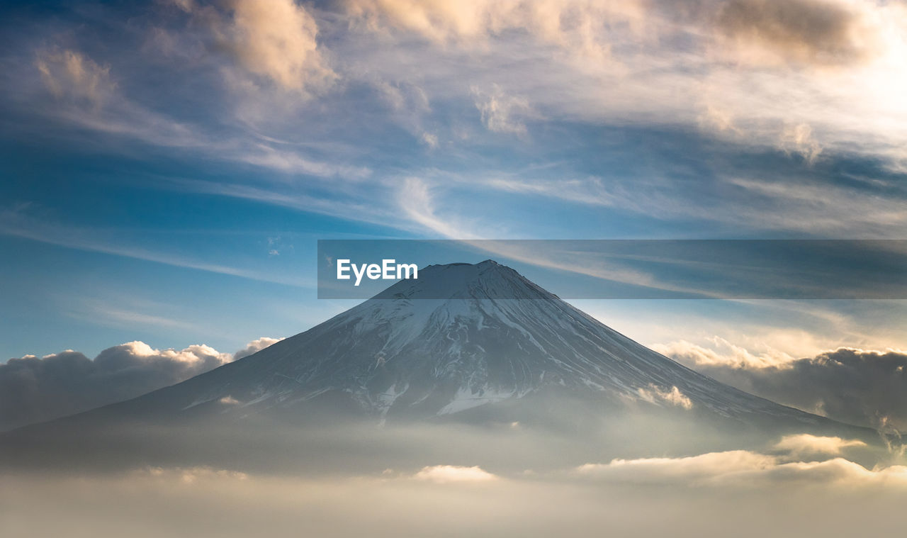 MAJESTIC VIEW OF SNOWCAPPED MOUNTAIN AGAINST CLOUDY SKY