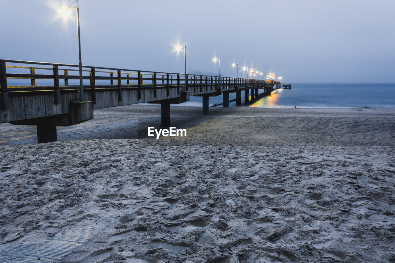 PIER ON SEA SHORE AGAINST SKY