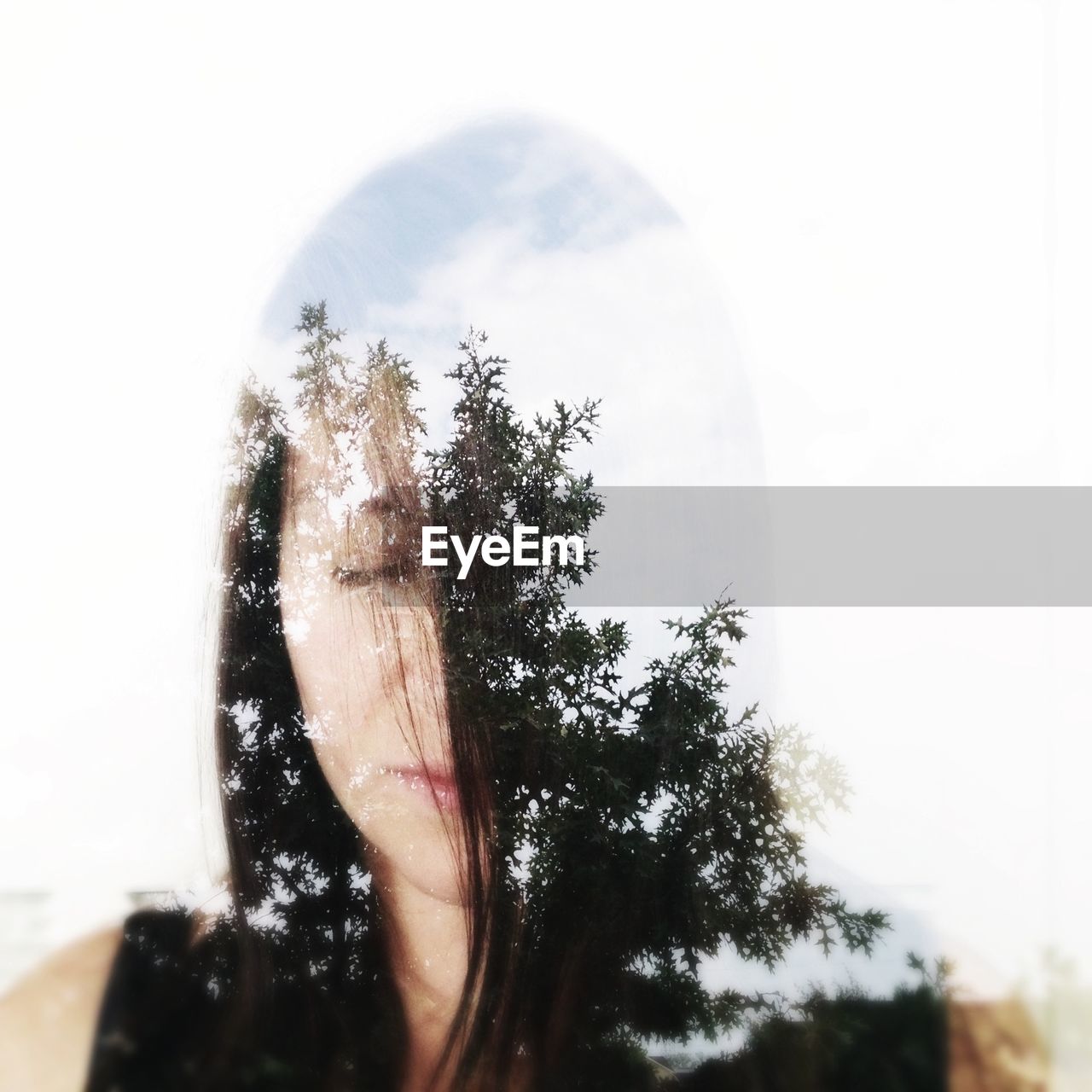 Double exposure of a young woman and trees