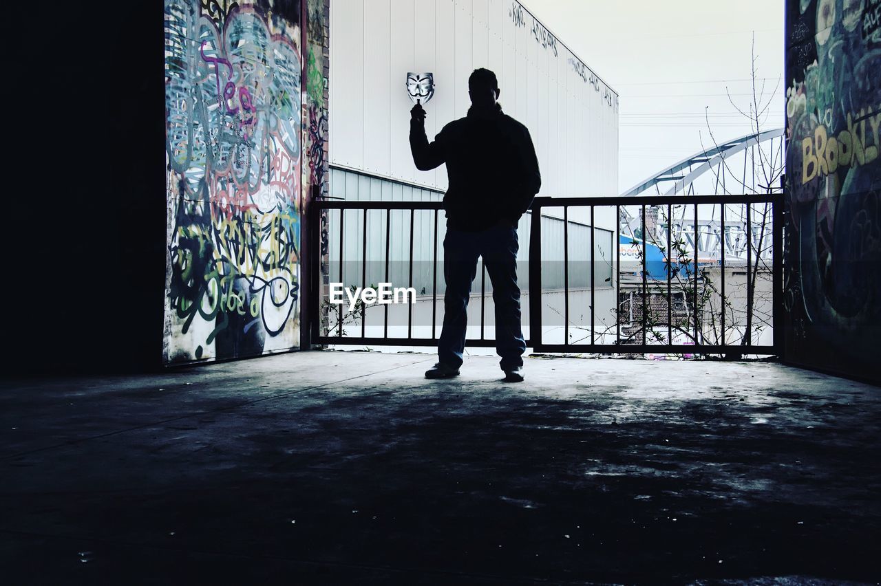 Silhouette man standing in corridor