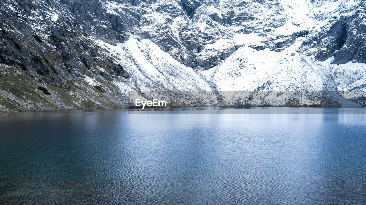 Czarny staw pod rysamy or black pond lake near the morskie oko snowy mountain hut in polish tatry