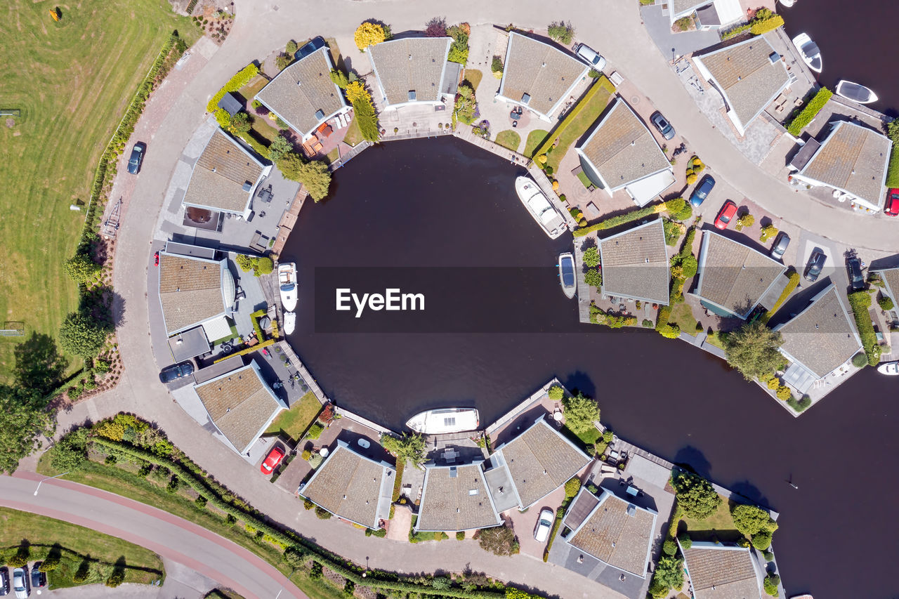 Aerial top shot from houses with boats in friesland the netherlands