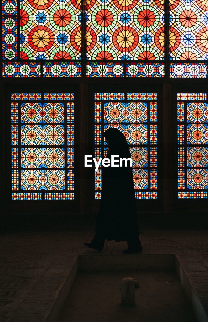 LOW ANGLE VIEW OF WOMAN WALKING IN WINDOW