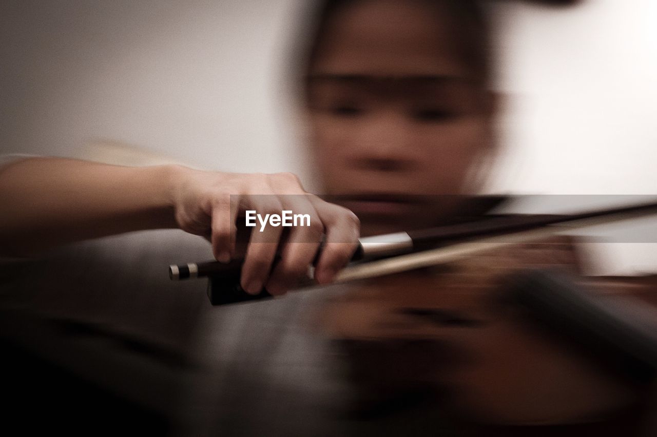 Blurred motion of woman playing violin